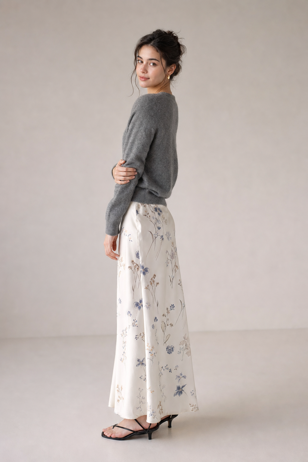Use canvas reference image node image-cRKSkIrNR6wfaikGBa7_N as the exact model identity and canvas reference image node 无标题-WnClyZaEmuHL3fqFVe4S7 as the exact clothing reference. Create a photorealistic full-body fashion outfit photo. Preserve the model's face, identity, hairstyle, body proportions, skin tone, and the clothing exactly: same garments, colors, pattern, fabric, fit, shoes, and accessories. Do not redesign or alter the outfit. Variation 4: thoughtful soft expression, standing with shoulders turned slightly away while looking back at camera, one hand lightly touching the opposite sleeve, refined fashion editorial composition, soft studio lighting, clean neutral background, realistic hands and anatomy, no text.