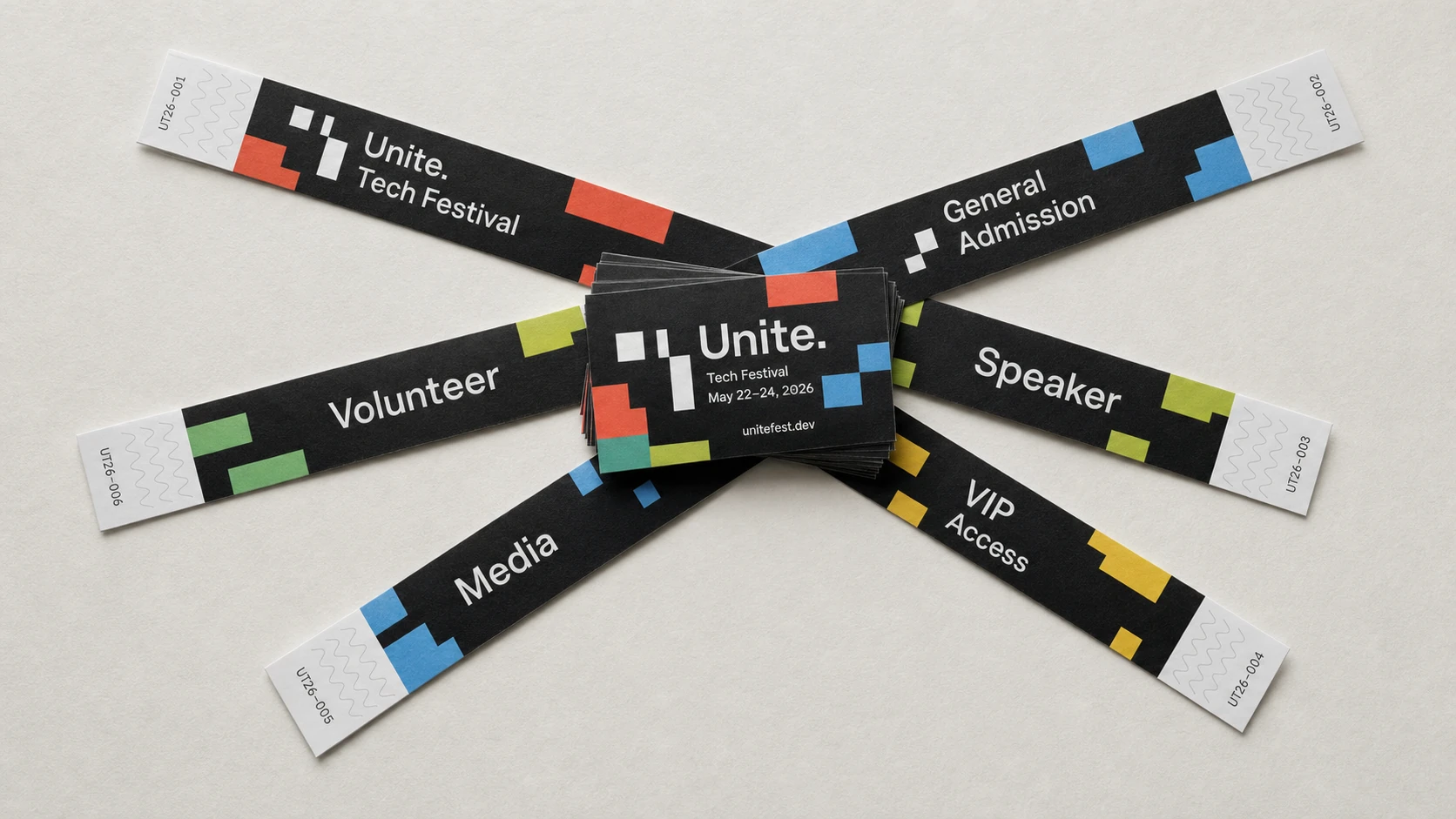 A flat-lay branding mockup of fanned-out black tech-festival admission wristbands radiating from a central stack of business cards, all sharing a playful pixel-