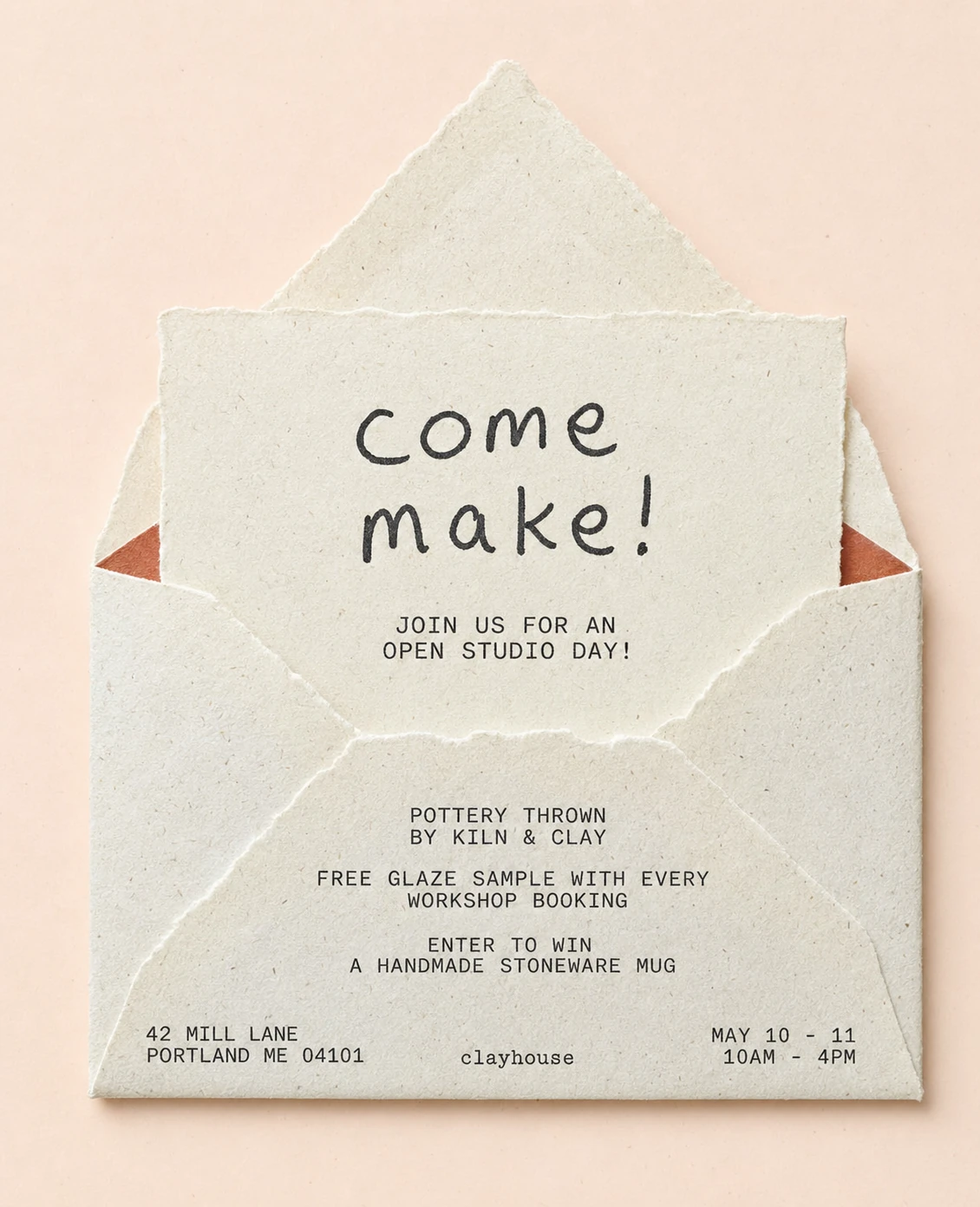 A handmade open-envelope invitation card photographed flat against a soft blush backdrop, featuring a hand-lettered headline and tidy event details.