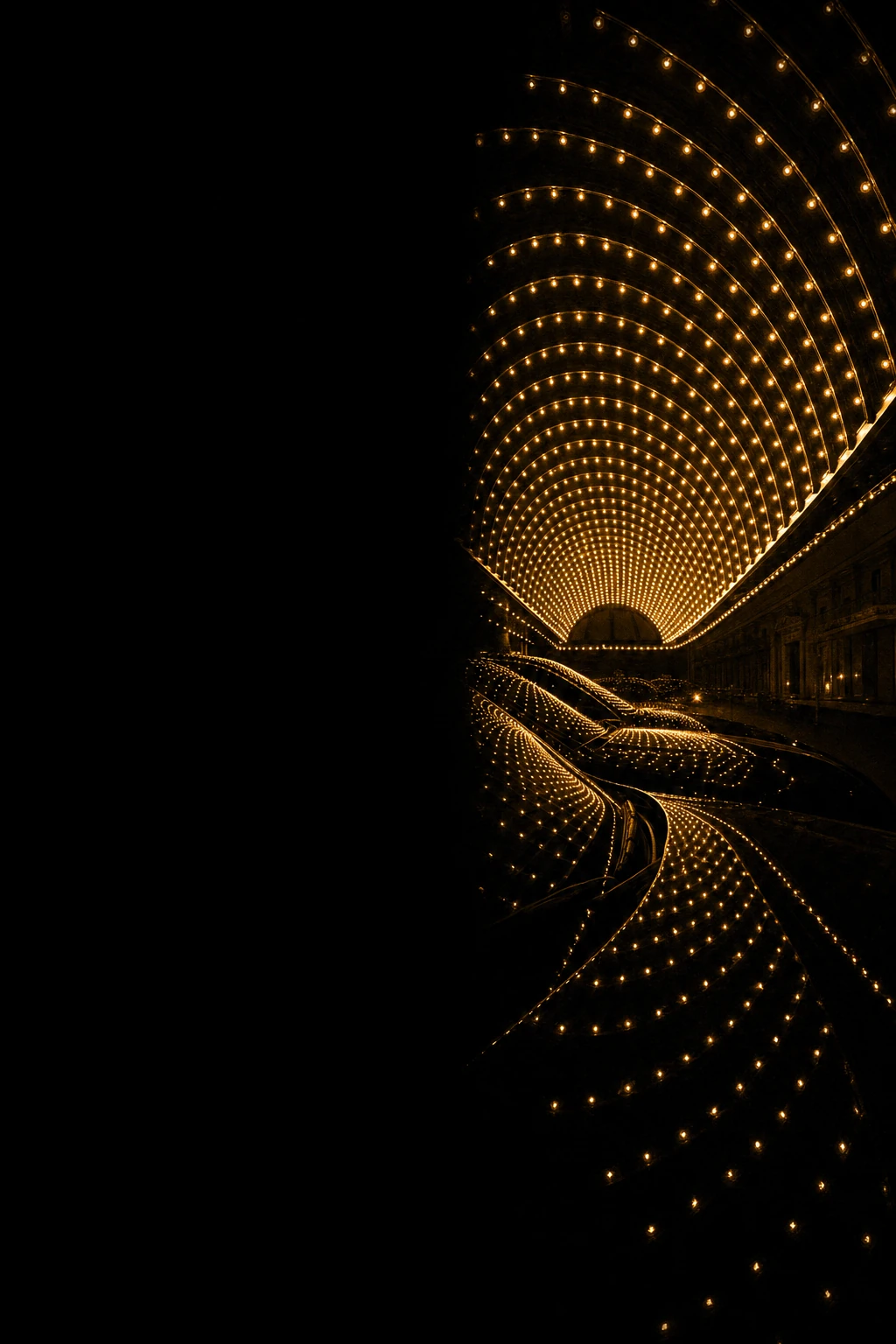 A dramatic night photograph of a grand domed architecture studded with hundreds of glowing golden lights forming sweeping radial patterns against deep black dar