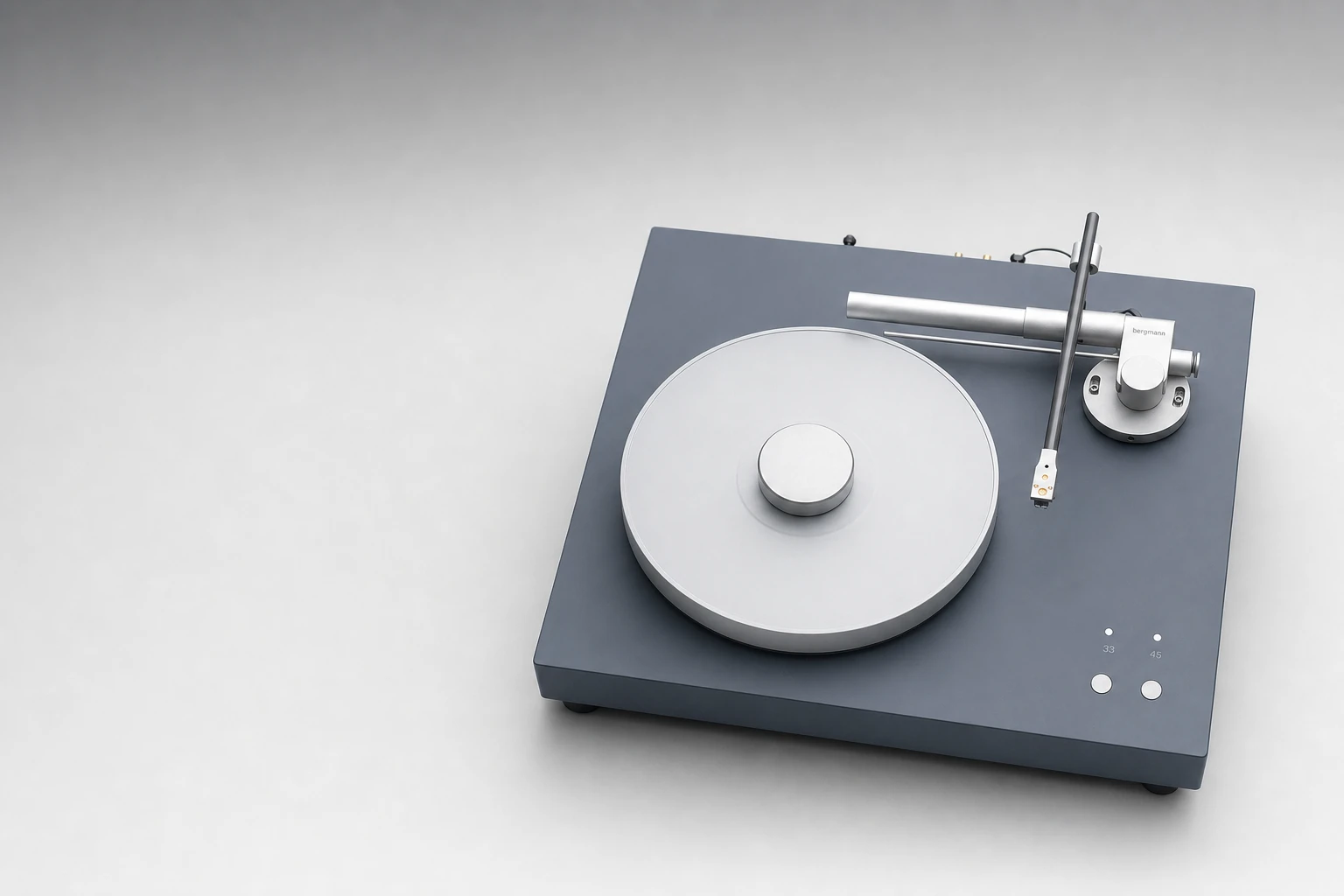 A premium high-end audio turntable photographed as a clean studio product shot on a soft gray gradient background.