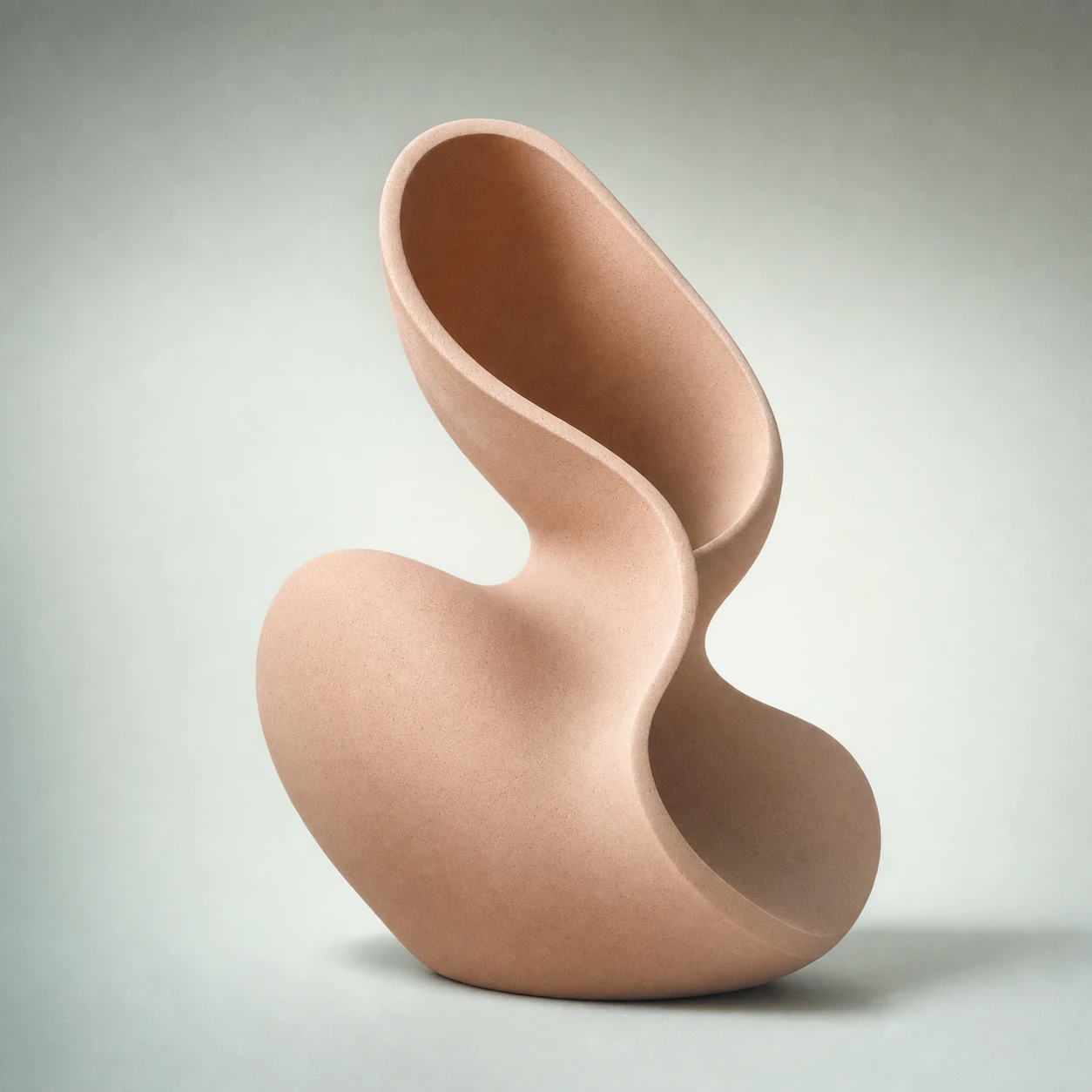 A single biomorphic ceramic sculpture with a smooth, looping organic form centered on a soft gradient studio background.