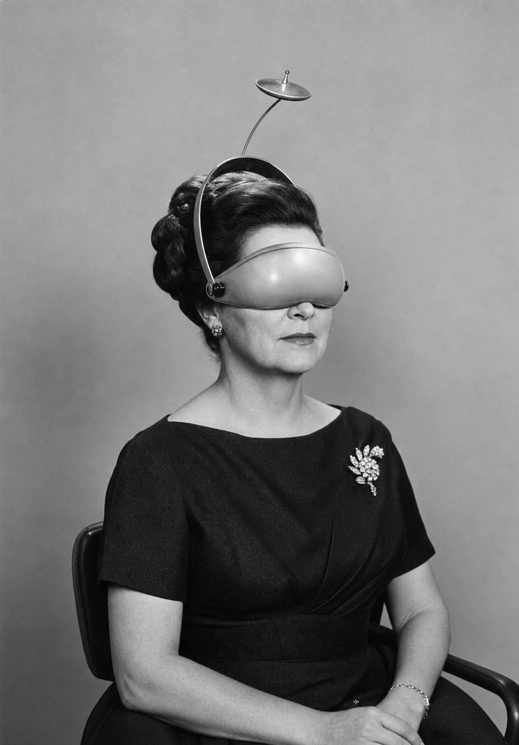 A vintage black-and-white studio portrait of a poised woman wearing a whimsical retro-futurist headset that obscures her eyes, blending formal elegance with sur