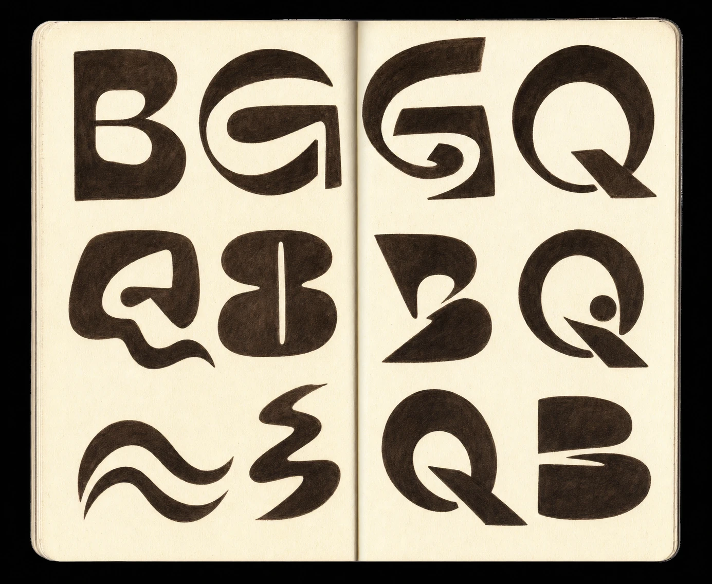 An open sketchbook spread filled with bold, hand-drawn experimental letterforms rendered in dense black ink on cream paper.