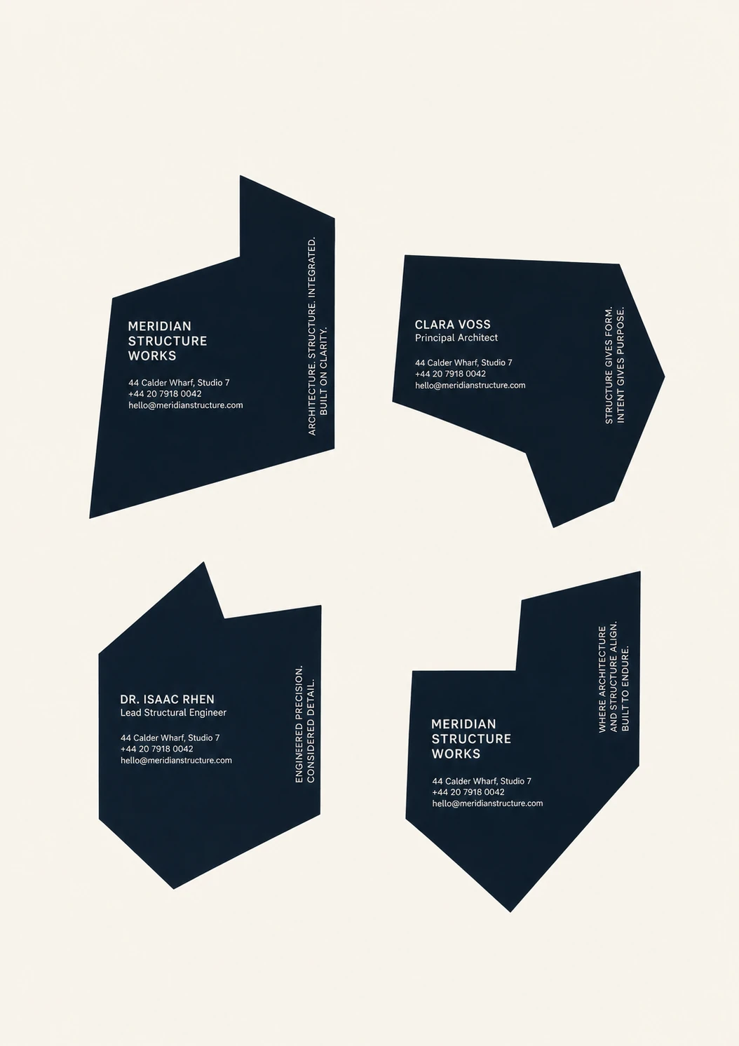 A minimalist brand identity layout showing four irregular angular dark navy shapes, each acting as a faceted business card with white contact typography, arrang