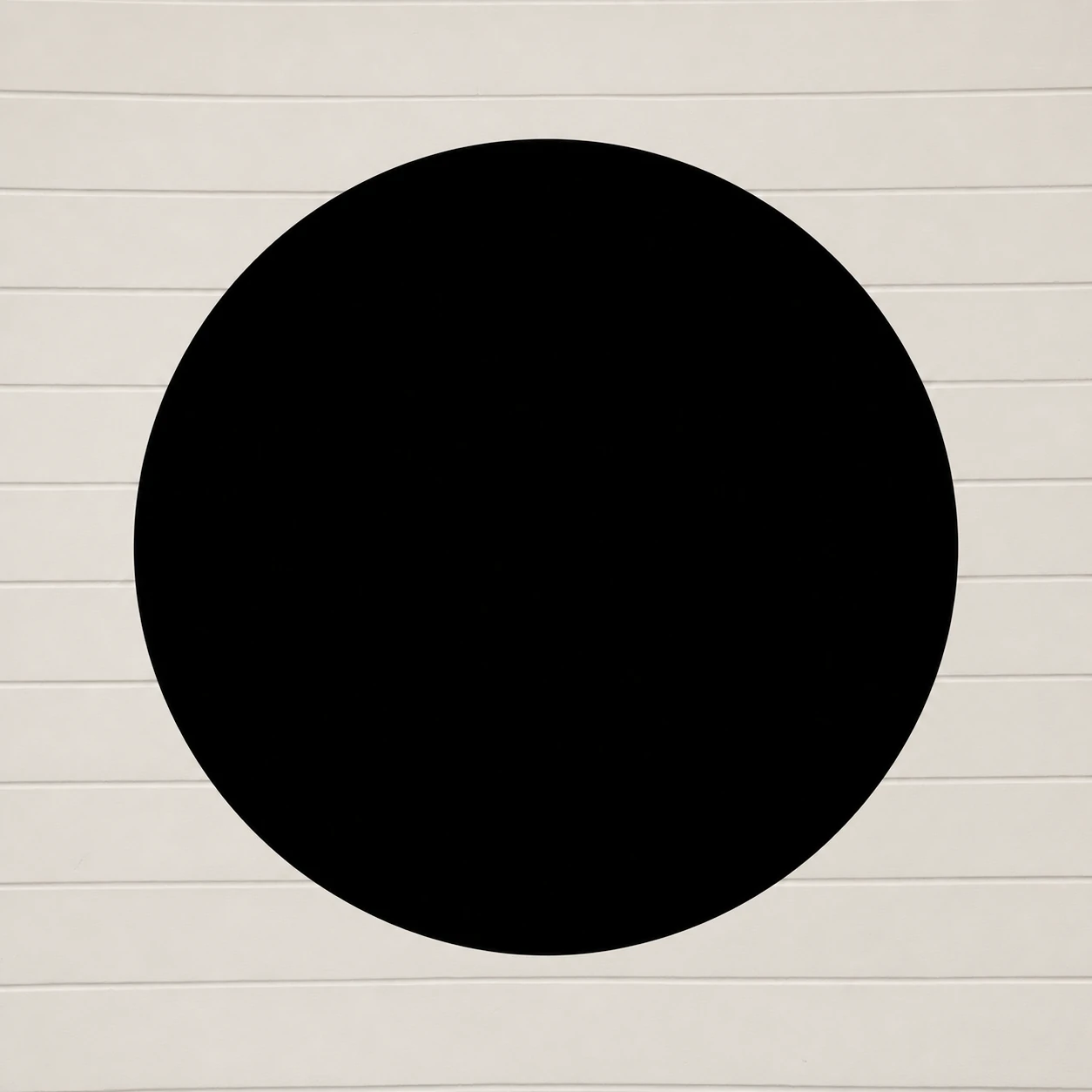 A bold solid black circle centered on a softly textured off-white background lined with subtle horizontal grooves.