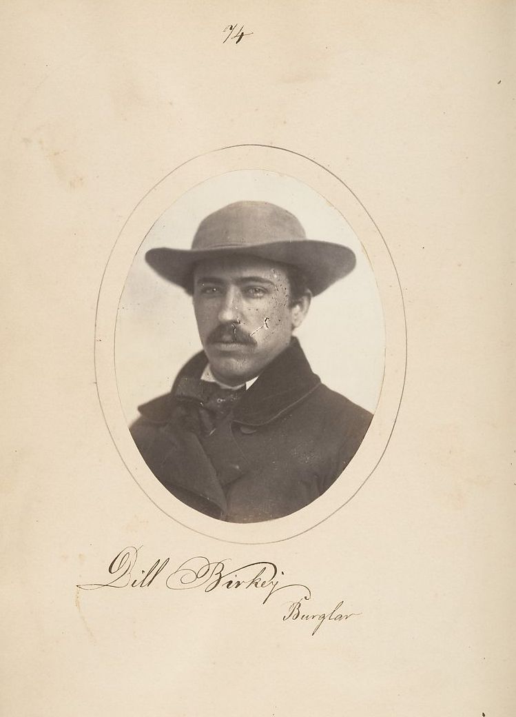 Vintage sepia-toned photograph of Bill Birkey, identified as a burglar, wearing a hat and dark suit.