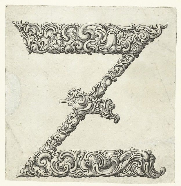 A detailed engraving of the letter 'Z' adorned with intricate scrollwork and floral motifs.