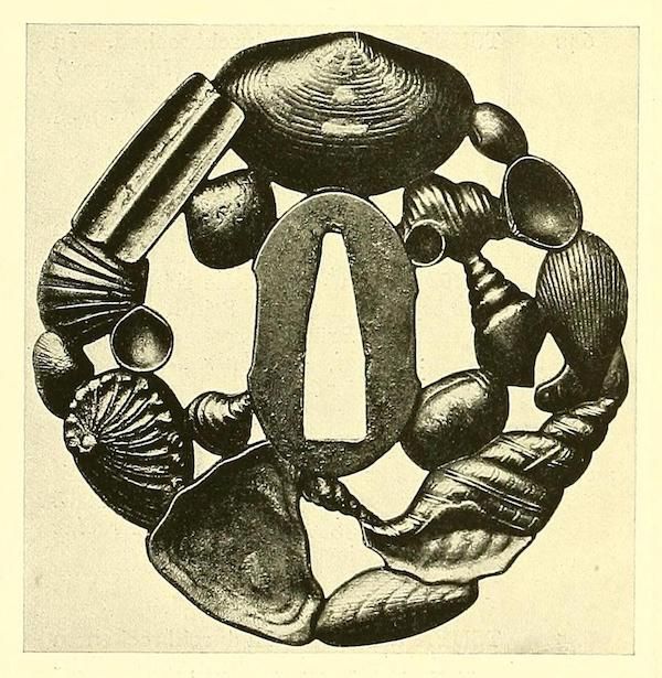 A detailed illustration of an antique brooch made of dark metal, decorated with shell-like motifs.