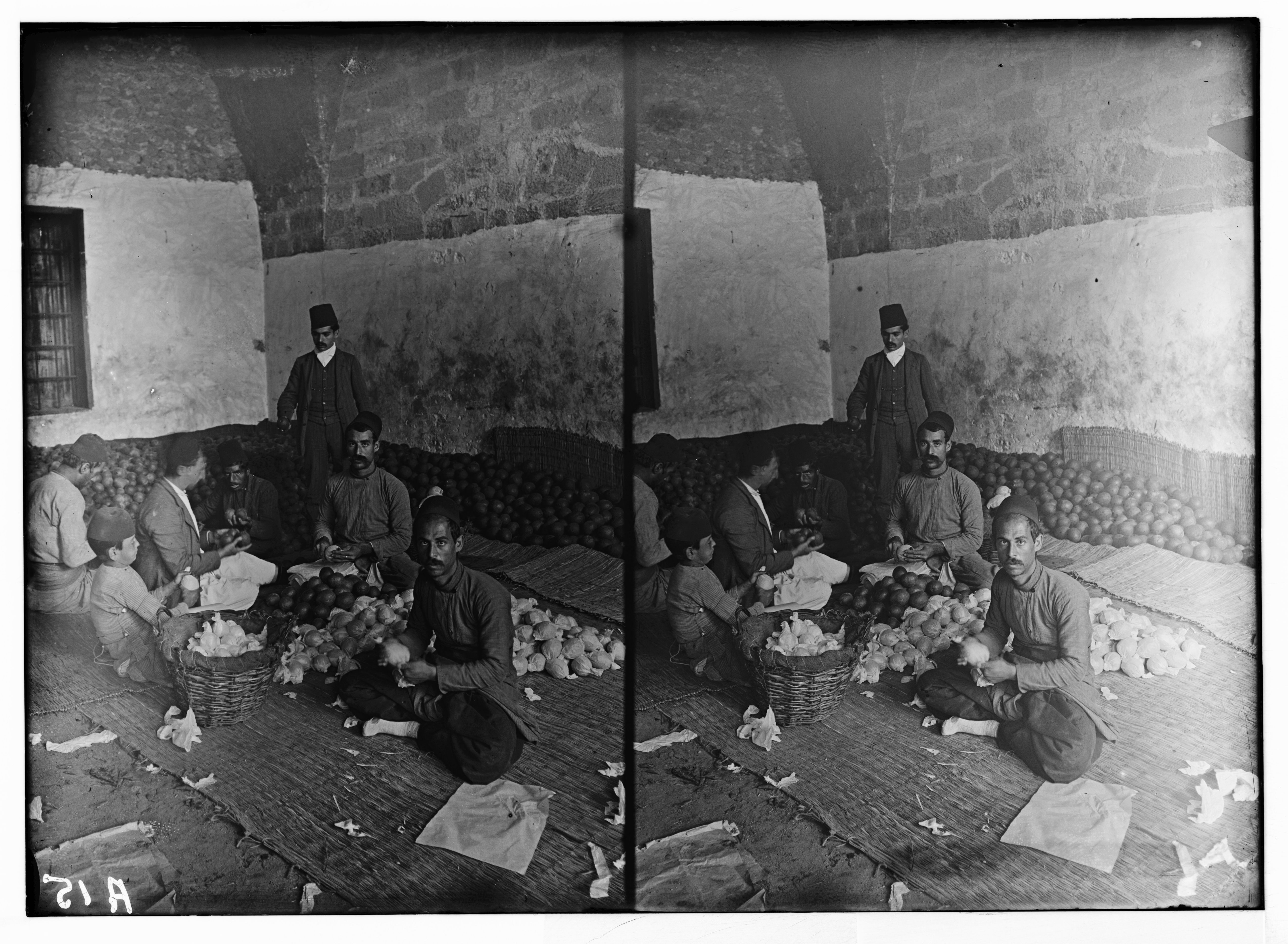 Stereoscopic photograph of a group of men gathered around a table with baskets of produce in a rustic room.