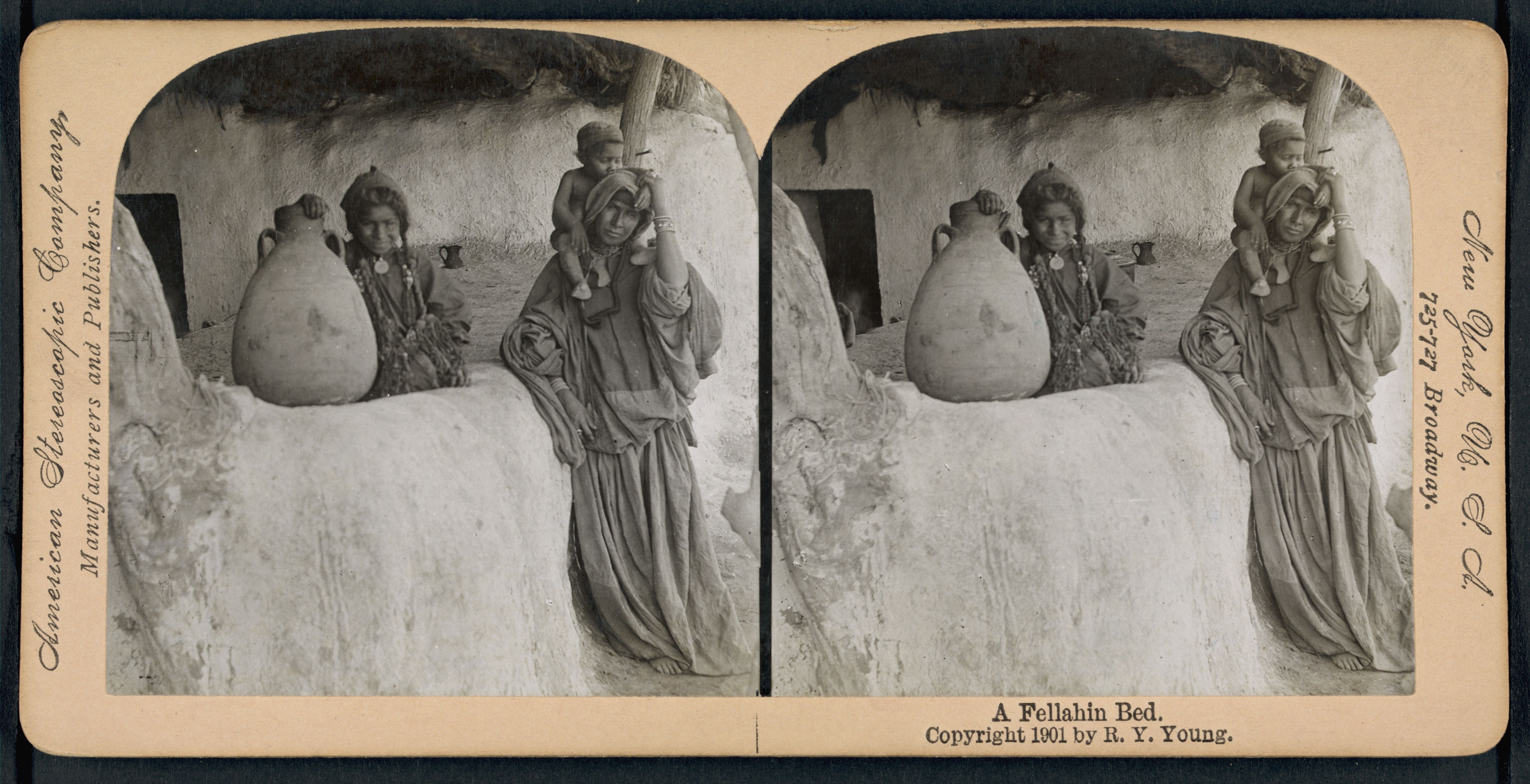 Stereoscopic card from 1901 featuring a photograph of a Fellahin Bed with a stone statue and ornate vessel.