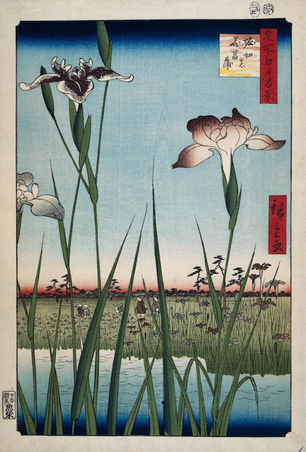 A Japanese woodblock print depicting a serene wetland scene with tall reeds, blooming irises, and a distant landscape.