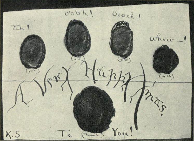 A black and white photograph of a card or paper with a pattern of thumbprints and handwritten text.