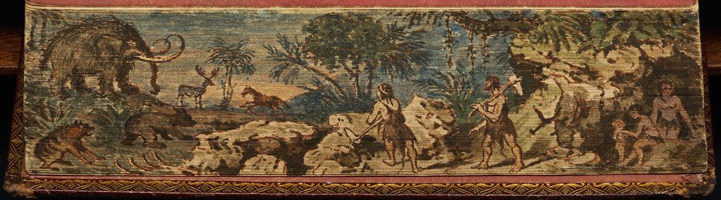 A long, rectangular tapestry depicting a prehistoric scene with a mammoth, people, and various animals in a lush landscape.
