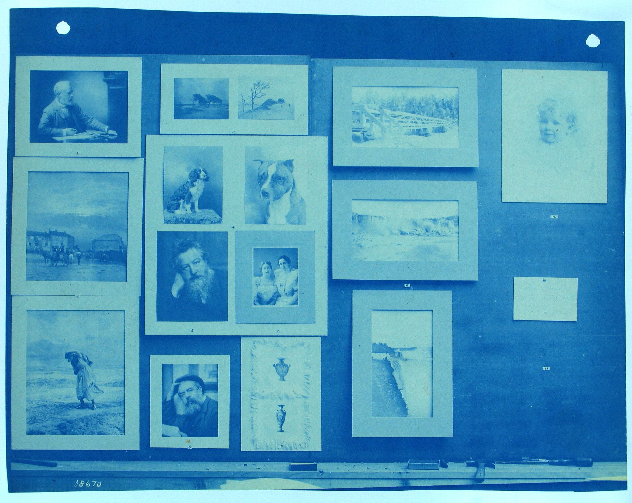 A vintage, monochromatic image of a board covered with framed pictures.