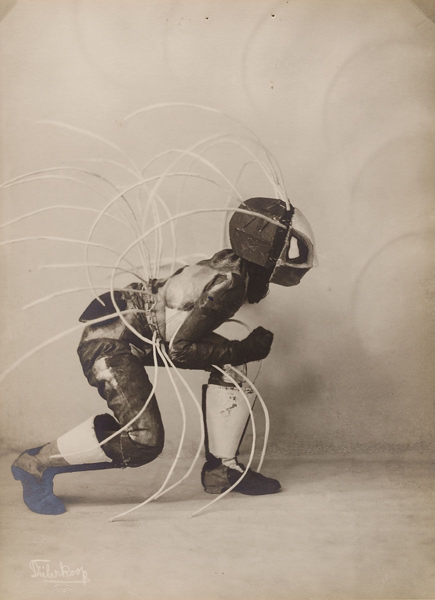 Vintage photograph of a football player kneeling with radiating lines.