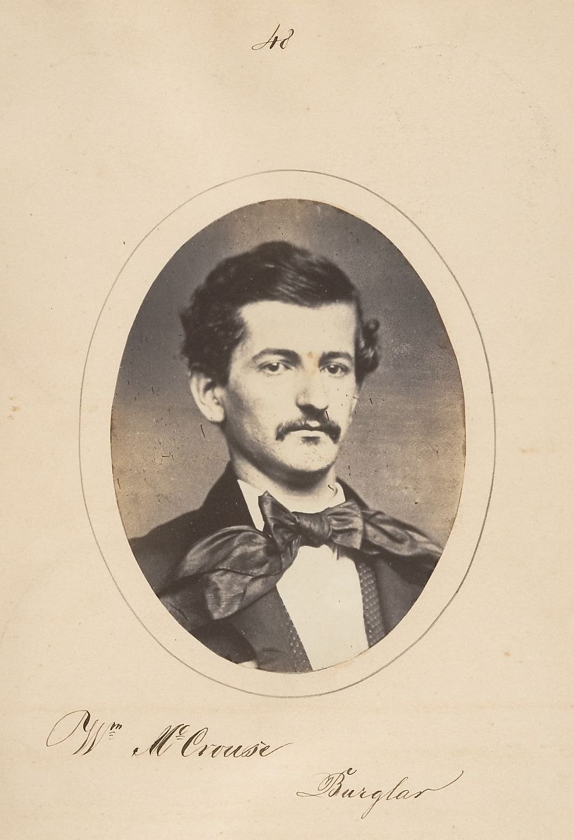Vintage sepia-toned portrait of W.M. Cruise, identified as a burglar, in an oval frame.