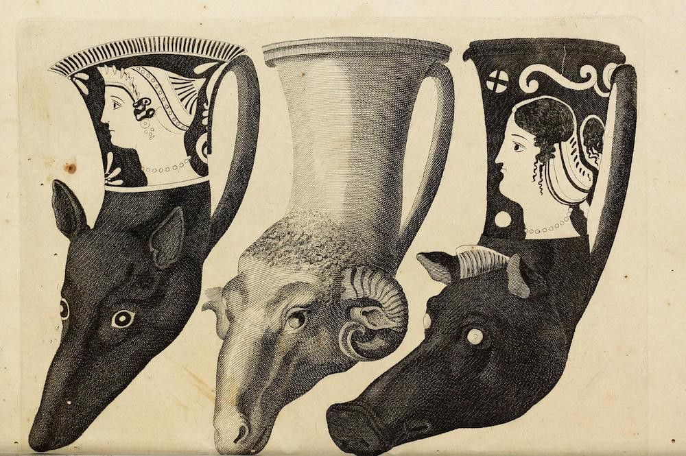 A black and white engraving depicting three ancient vessels and a ram's head.