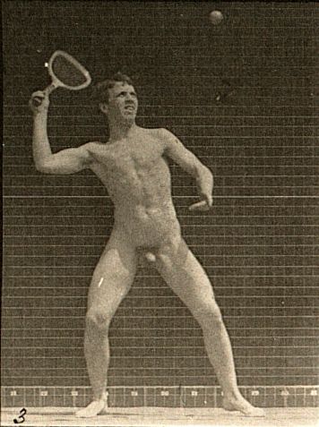 Vintage sepia-toned photograph of a nude man playing tennis, captured mid-swing with a raised racket and a ball in the air.