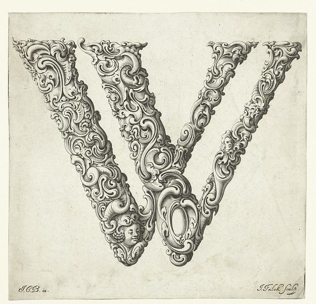 A detailed black and white engraving of the letter 'V' heavily ornamented with intricate floral and scrollwork designs.