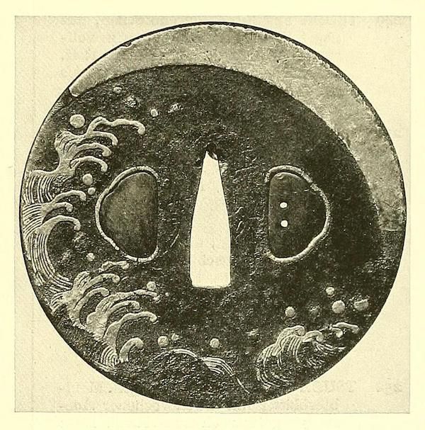 A vintage black and white image of a Japanese tsuba, a sword guard, with intricate wave patterns and openings for the sword's tang.