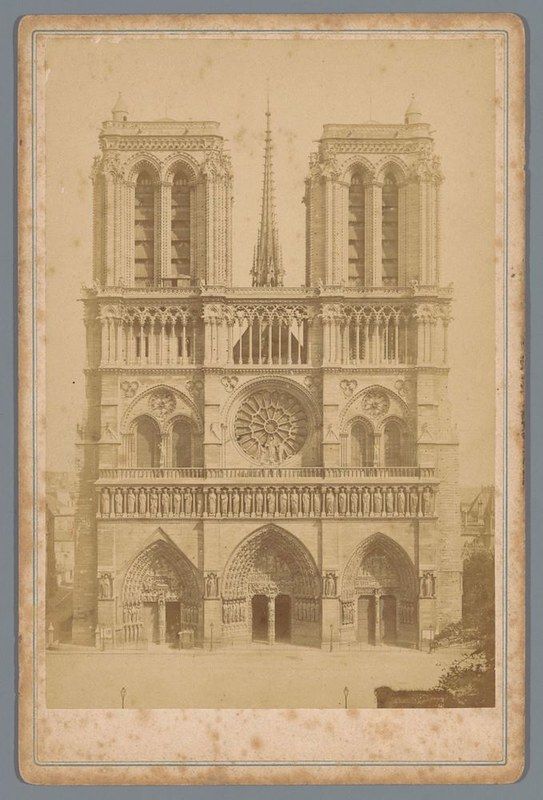 Vintage photograph of the facade of Notre Dame Cathedral in Paris, showcasing its Gothic architecture and intricate details.