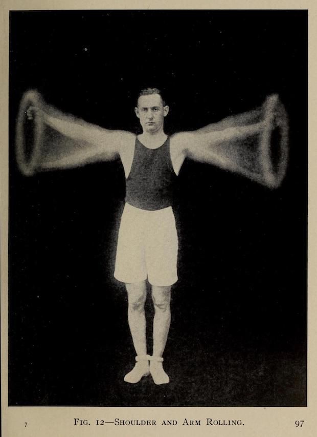 Vintage photograph of a man performing shoulder and arm rolling exercise.