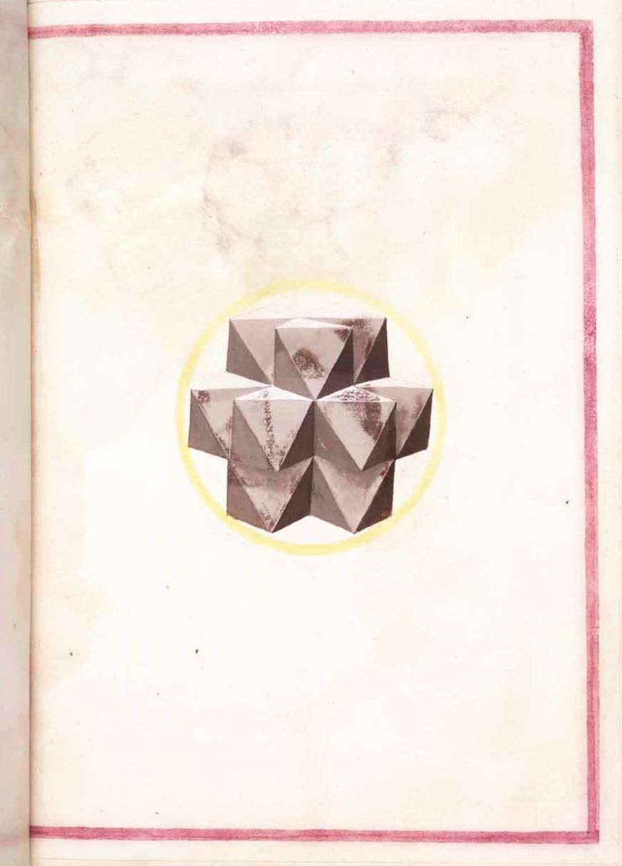 A page from a book with a complex geometric shape resembling a star or crystal in the center.