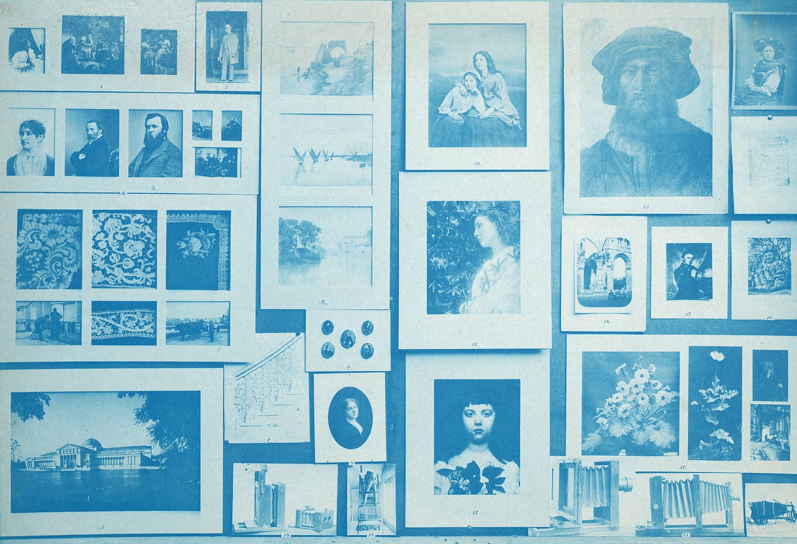 A wall covered with a collection of framed pictures and artwork in shades of blue.