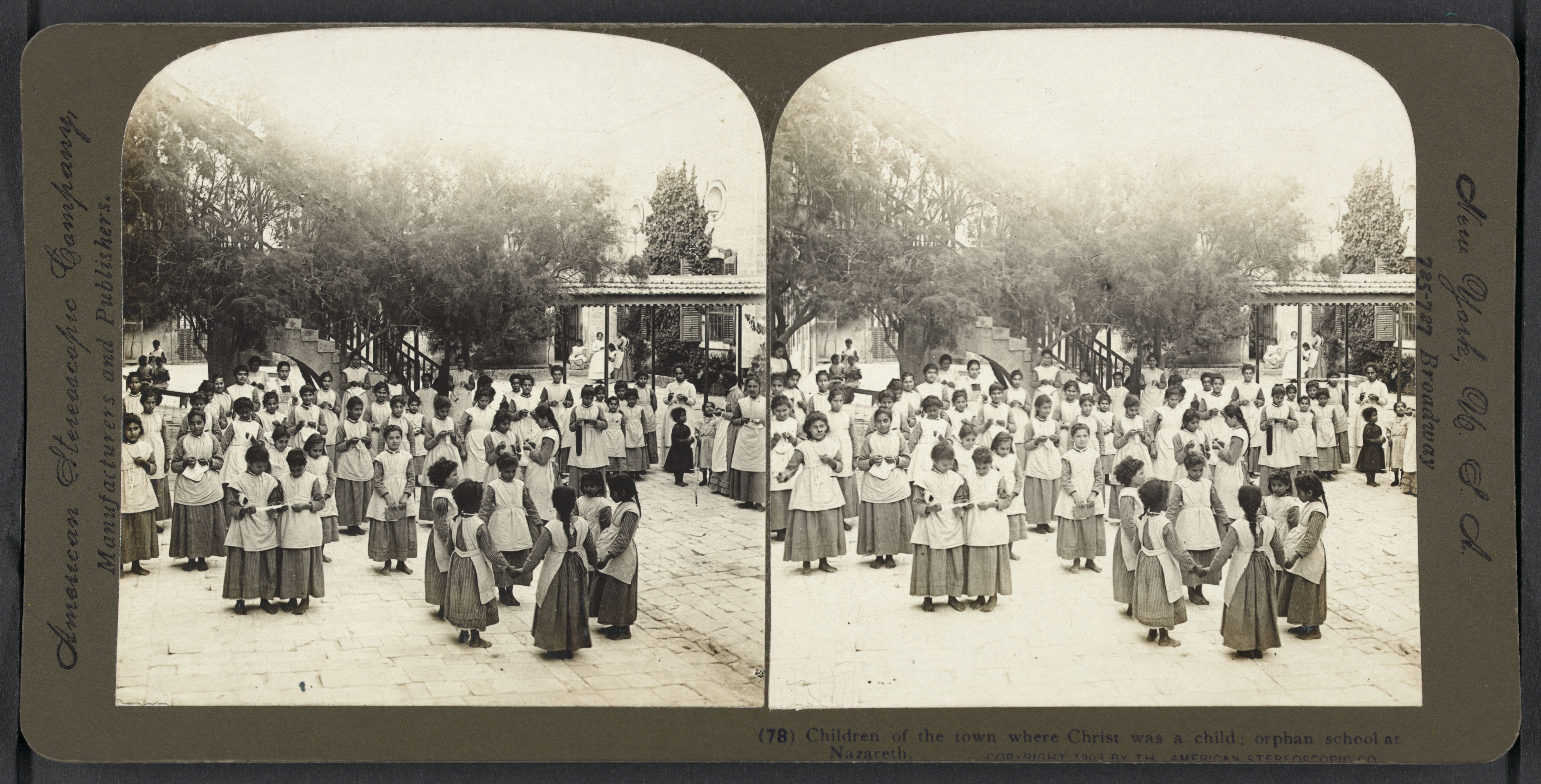 Stereoscopic photograph of a large group of children in uniform standing in a courtyard at an orphanage or school in Nazareth.