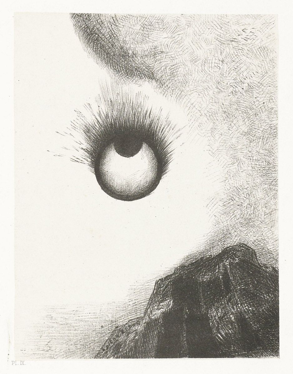 Close-up of an eye with a rocky landscape below.