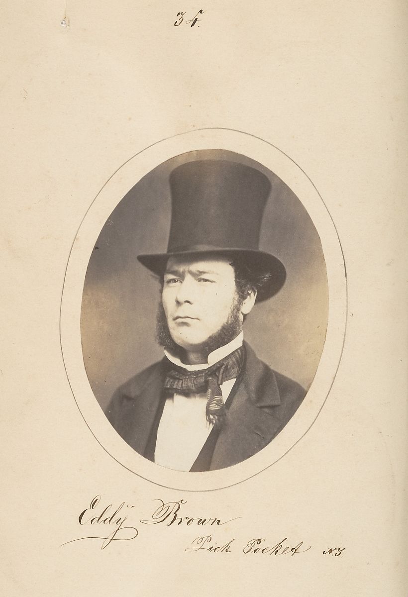 Vintage portrait of Eddy Brown in a top hat and formal attire, with handwritten text below.