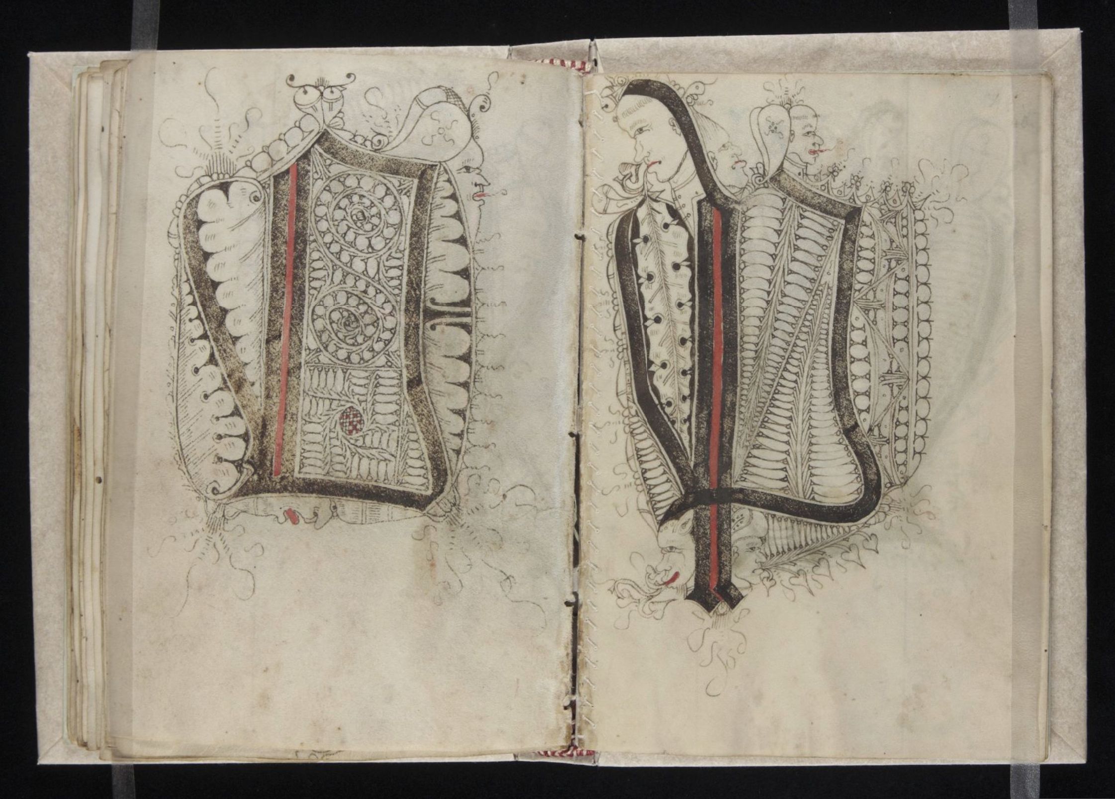 An open page spread from a historical manuscript featuring two large, ornate letters 'M' and 'P' decorated with intricate patterns and human figures.