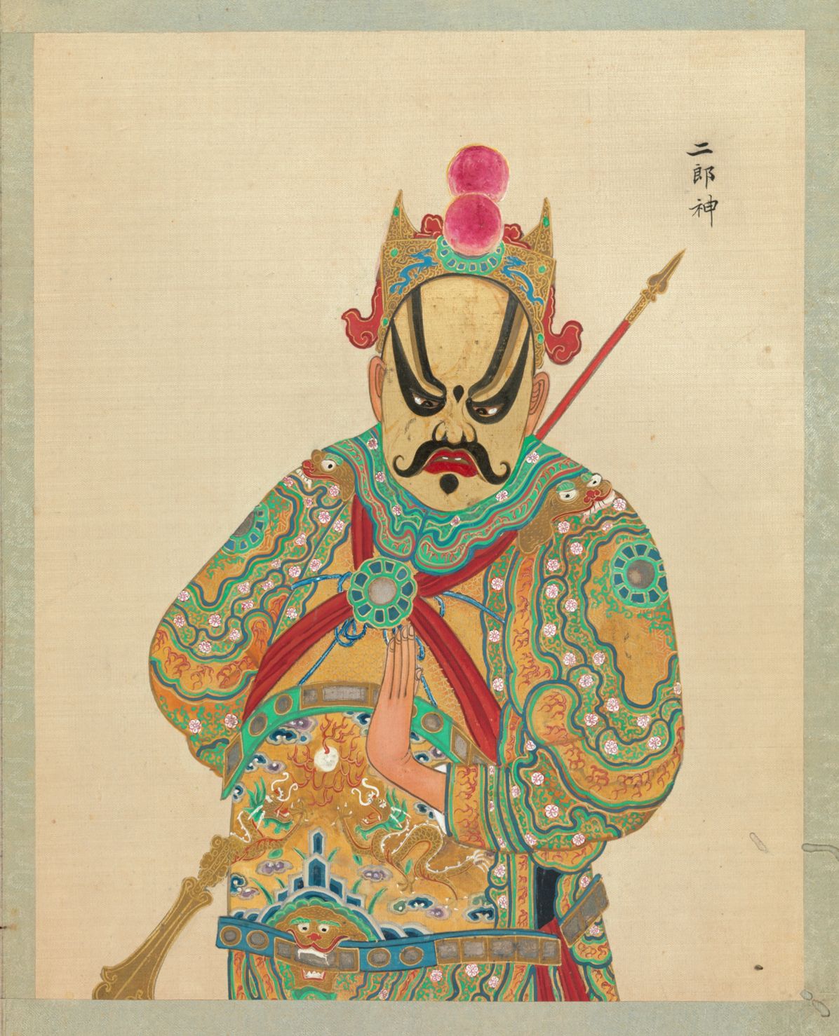 A full-body portrait of a man in elaborate traditional Chinese opera attire, holding a golden spear.