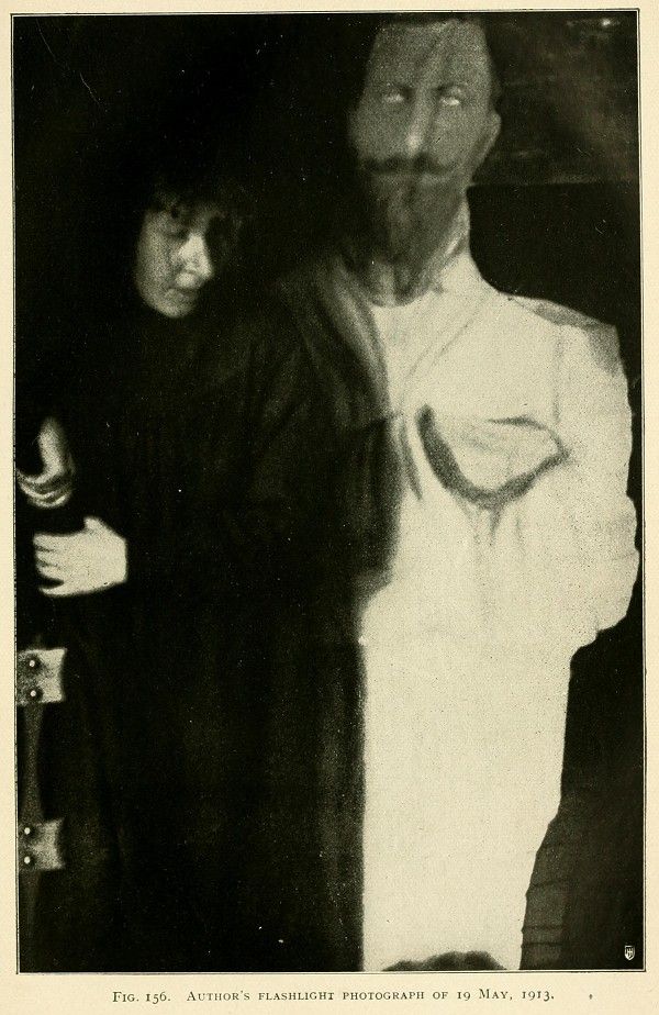 A vintage black and white photograph of a man and a woman, taken with a flashlight in 1913.