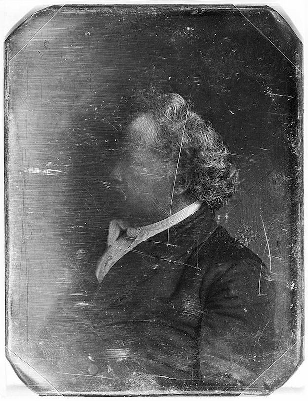 A vintage daguerreotype portrait of a man in profile.