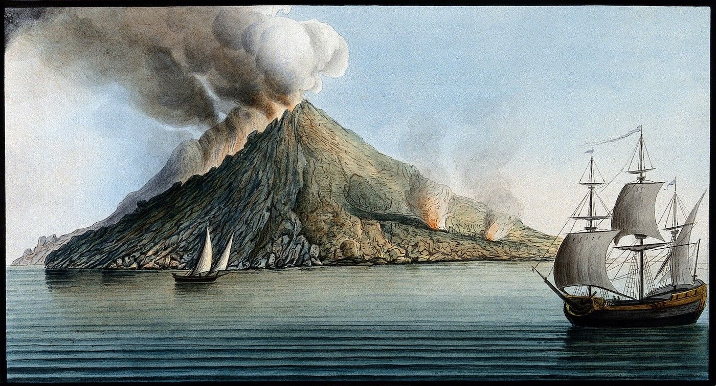 Watercolor painting of a volcanic eruption on an island with two sailing ships in the foreground.