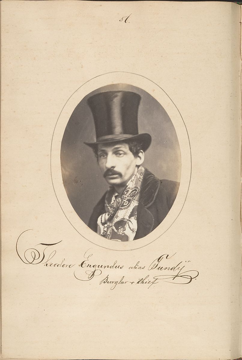 Sepia-toned photograph of a man in a top hat and formal attire, identified as a burglar and thief in cursive handwriting below the portrait.