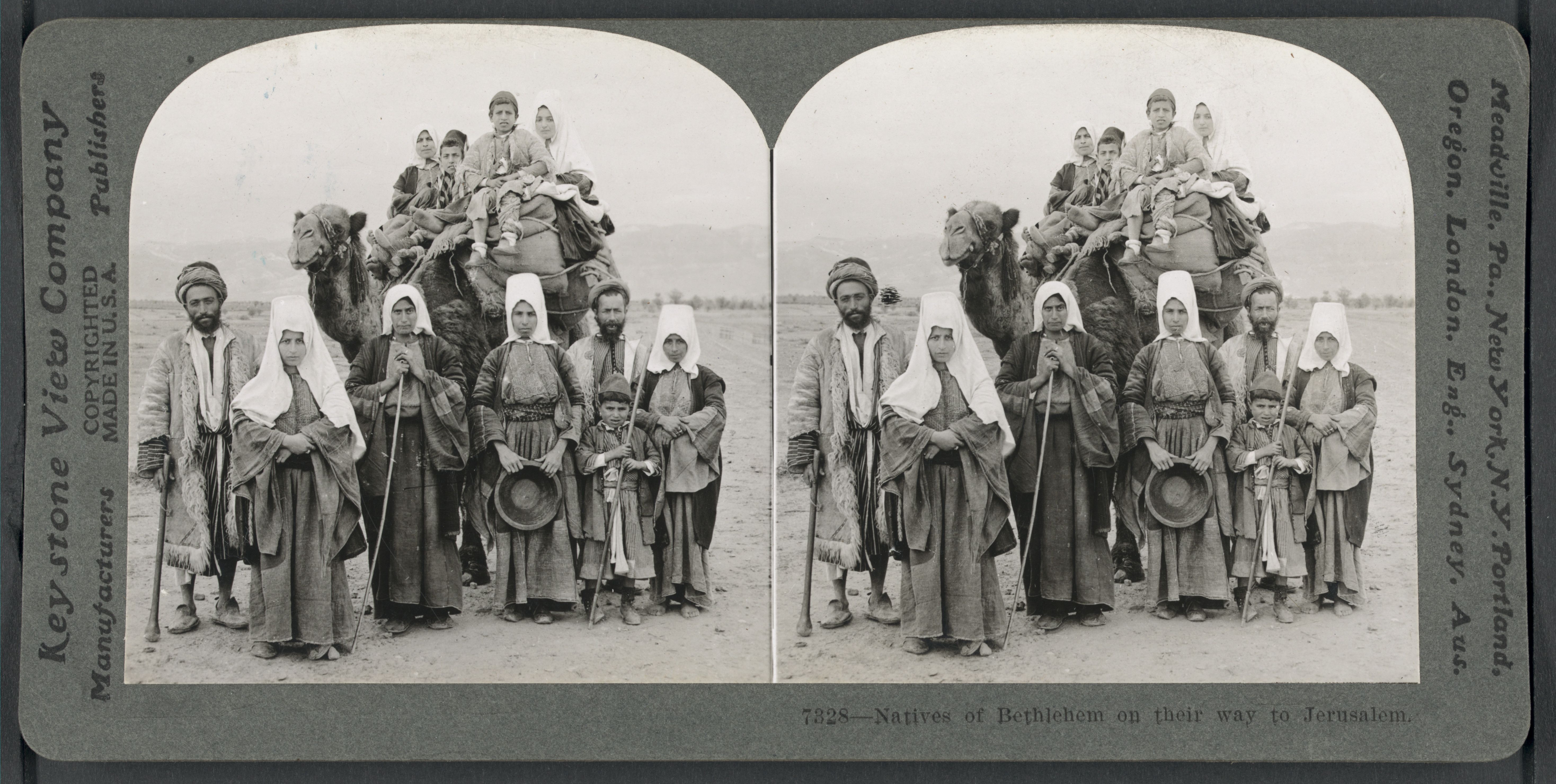 Stereoscopic photograph of a group of people riding camels on a dusty road, labeled as "Natives of Bethlehem on their way to Jerusalem."