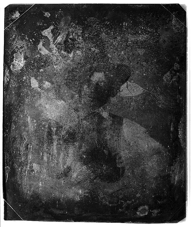 A black and white abstract image with a lot of texture and scratches.