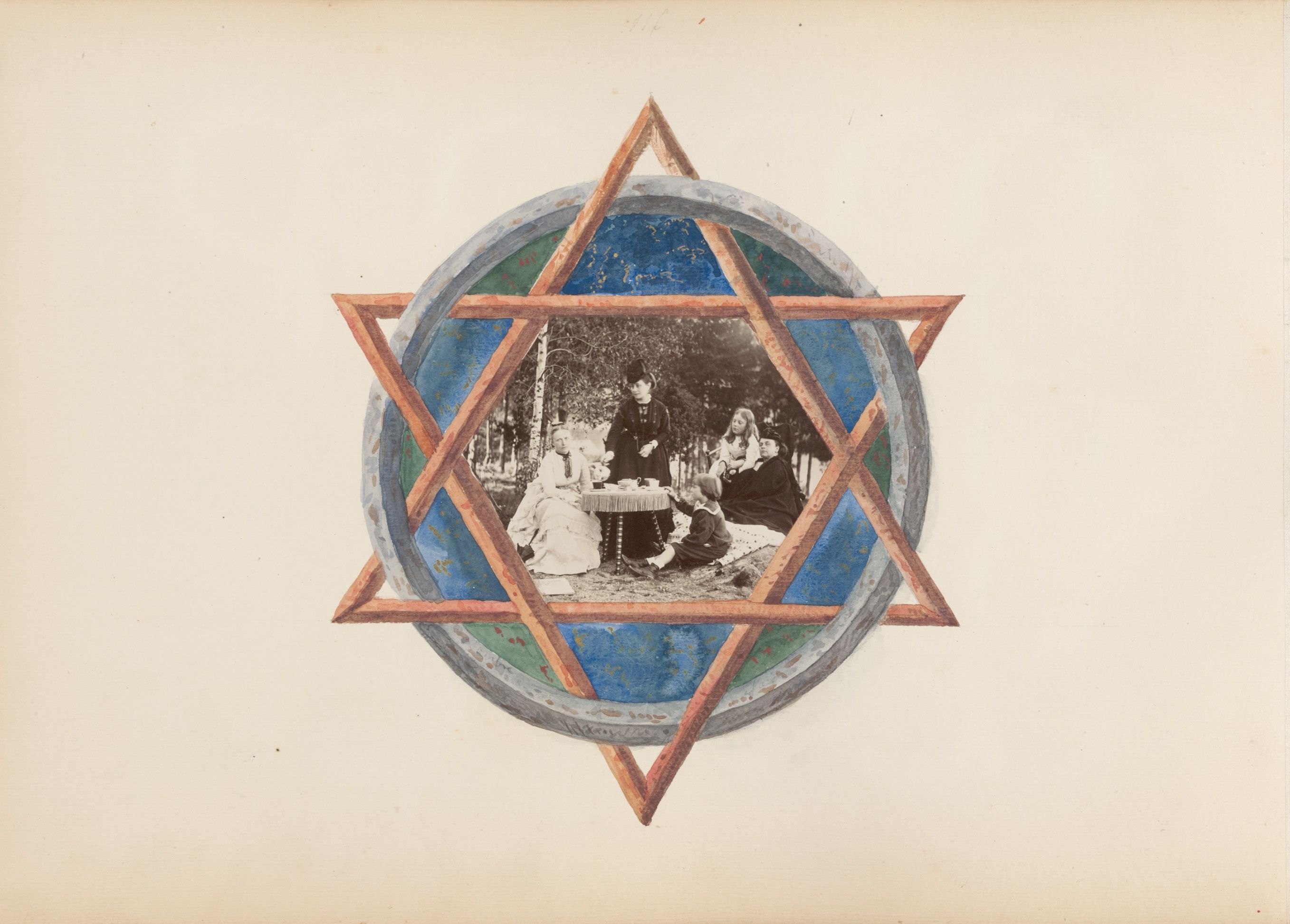 A vintage photograph of a group of people around a table, mounted within a decorative star-shaped frame.