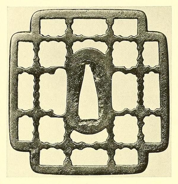 A square metal grid with a complex, repeating pattern of rectangular and wavy-edged openings.