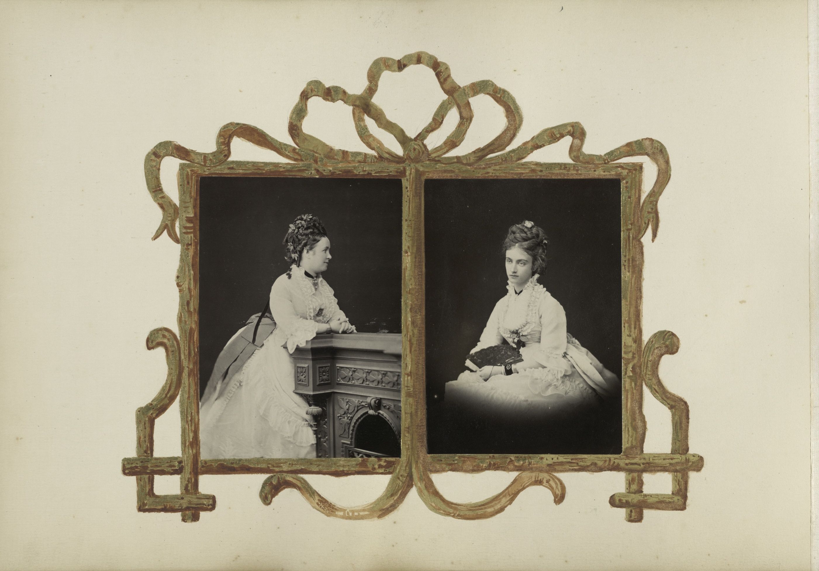 A vintage photograph of two women in Victorian dresses, framed in an ornate, gold-toned frame.