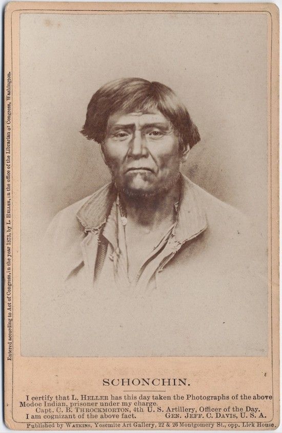 Vintage photograph of Schonchin, a Modoc prisoner, in a dark coat and white bandanna, with text certification at the bottom.