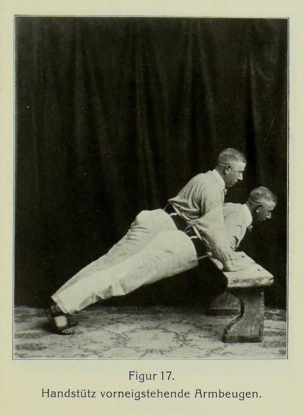 Vintage black and white photograph of a man performing an exercise with his feet elevated on a bench.