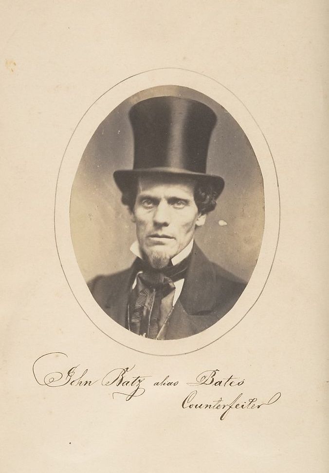 Vintage photograph of John Bates, a counterfeiter, wearing a top hat and dark suit.