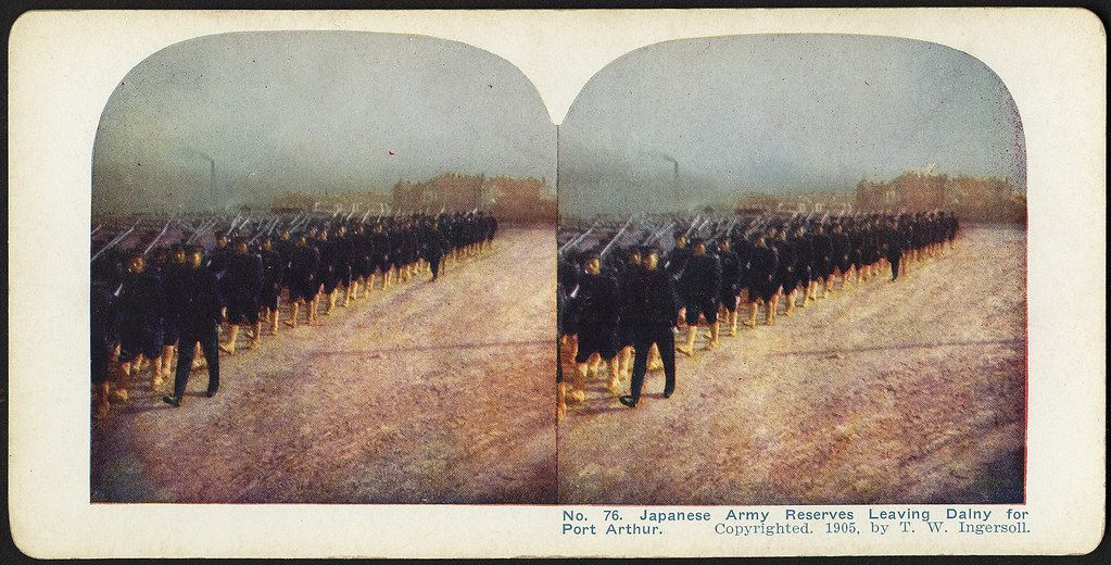 Stereoscopic photograph of Japanese army reserves marching across a field in 1905.