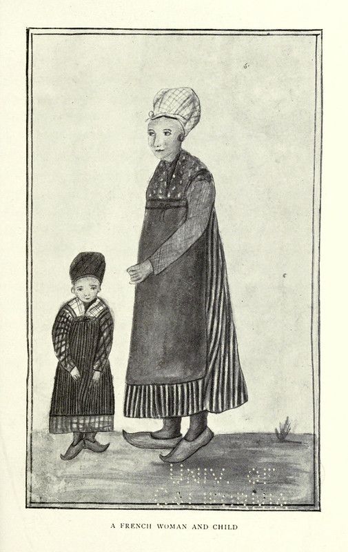 A French woman and child in traditional clothing.