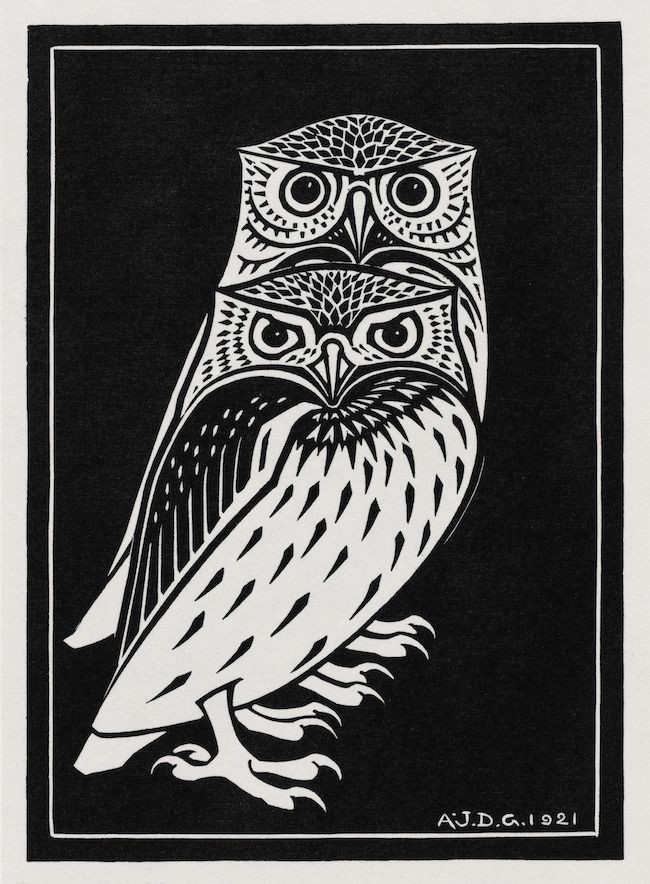 A black and white illustration of an owl, rendered in a stylized, graphic style reminiscent of woodcut or linocut prints. The owl is depicted in a full-body portrait, perched with its talons gripping a branch. The artist's signature, 'A.J.D.G. 1921', is written at the bottom of the image.