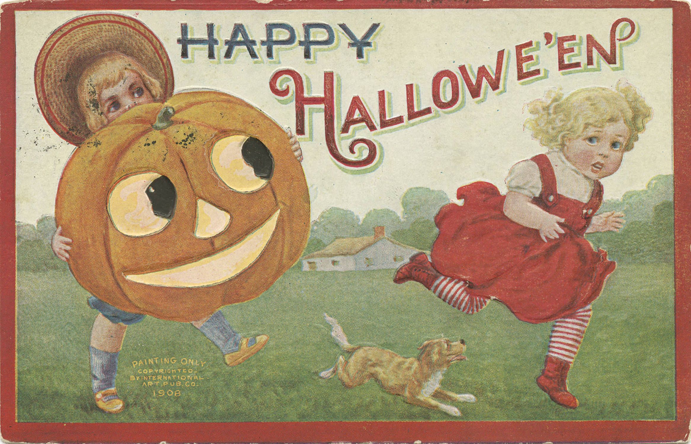 Vintage Halloween postcard from 1908 depicting two children, one wearing a pumpkin head, running on a grassy field with a dog, and a house in the background. The words "HAPPY HALLOWE'EN" are written above the scene.